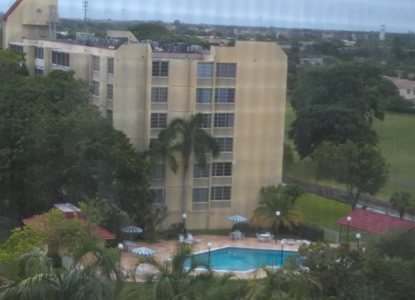 Aerial view of the building and its on-site pool