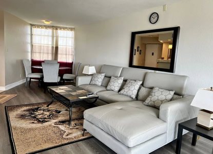 Living room seating area with mirror and coffee table